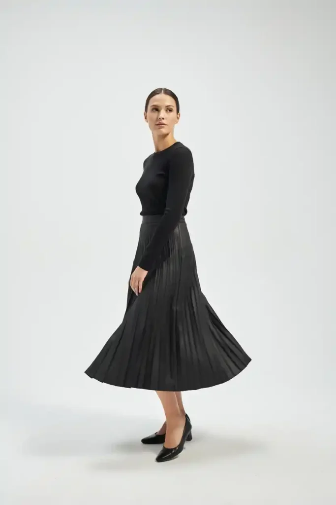 16 Chic All-Black Outfit Ideas 15 Black Pleated Midi Skirt with a Fitted Black Top