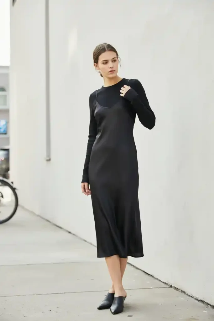 16 Chic All-Black Outfit Ideas 3 Black Slip Dress over a Black Long-Sleeve Top